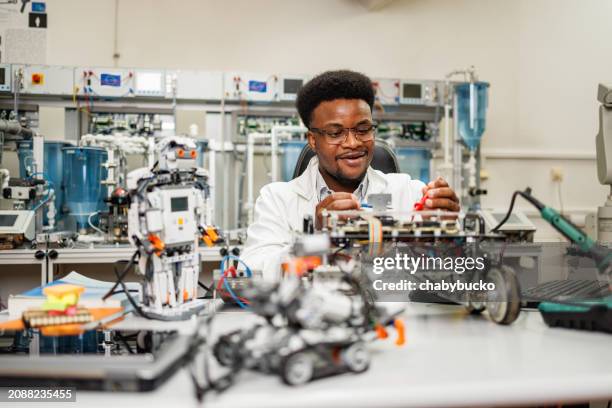 african american engineer examining ai robot